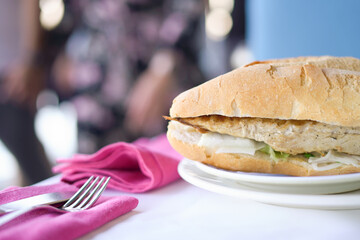 Popular turkish dish mackerel fish in bread with vegetables on a table in a restaurant