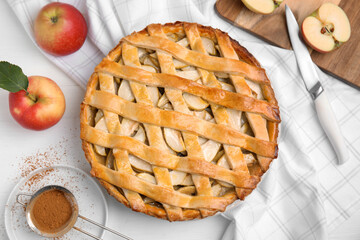 Delicious traditional apple pie on white table, flat lay