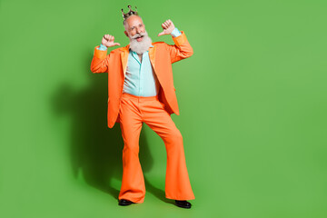 Full length body size view of attractive cheerful cool man presenting himself isolated over bright green color background