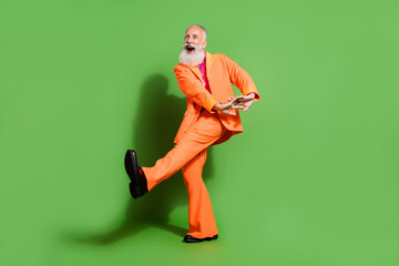 Full length body size view of attractive funny cheerful man dancing fooling good mood isolated over bright green color background