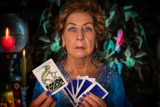 A fortune teller shows the tarot card of death. Witch showing the image of death