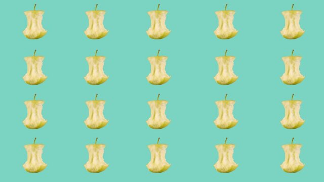 Rows, many stubs of a bitten off ripe yellow apple rotate on a blue background.Minimalistic animated design style. Elements concept blank background template. The art of minimal motion design.