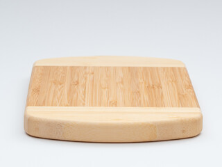Bamboo cutting board on a white background.