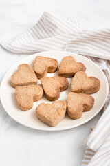 homemade heart-shaped cookies on a plate, Valentine's day gift with love, gluten-free buckwheat flour pastries.