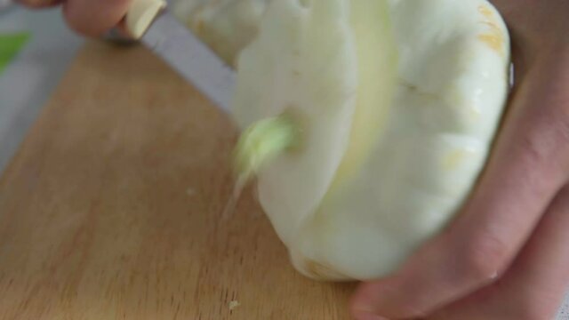 Mens hands cut the pattison for cooking. Homemade food vegetables
