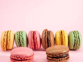Fototapeta na wymiar colorful macarons on pink background