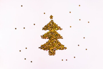 Christmas tree of golden sparkling stars on pink background. Magic Christmas and Happy New Year...