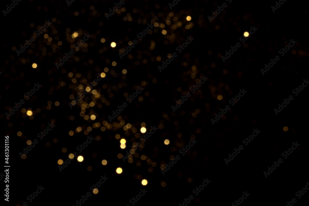 Wall mural golden blurred bokeh lights on black background. glitter sparkle stars for celebrate. overlay for yo