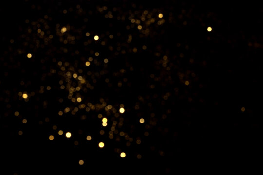 Golden Blurred Bokeh Lights On Black Background. Glitter Sparkle Stars For Celebrate. Overlay For Your Design