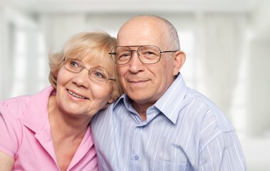 Happy older mature classy couple hugging, thinking of good future.