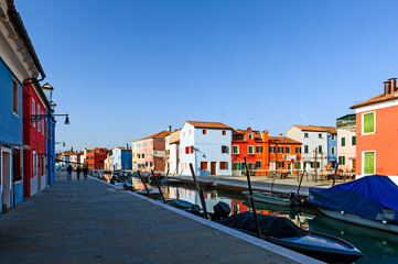Fototapeta na wymiar Italy. Veneto, Burano. Coloured houses along canal in Burano village