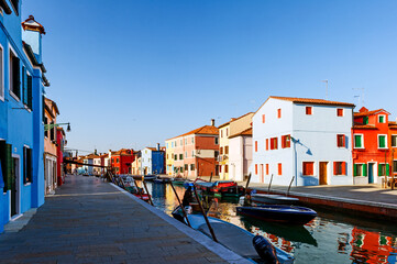Fototapeta na wymiar Italy. Veneto, Burano. Coloured houses along canal in Burano village