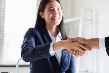 Business woman greeting with shake hands to congratulate after agreement with partner. Two business...