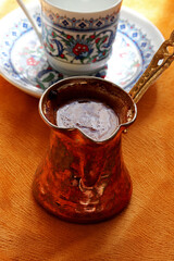 cup of Turkish coffee with copper coffeepot