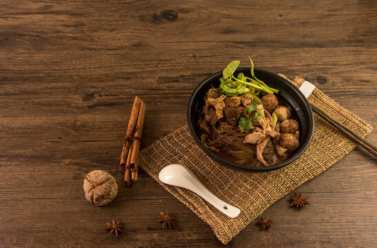 Hot and Spicy Nam Tok noodles soup with meat balls.Thai boat noodles is Street food of Thailand style, that famous noodles soup,Thai Boat noodles soup or Guay tiew reua, Rice noodles thicken soup.