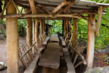 wooden gazebo with chairs and benches