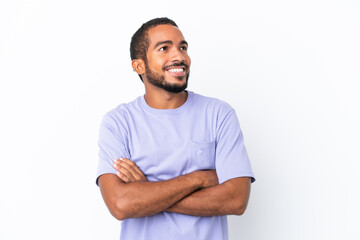 Young Ecuadorian man isolated on white background looking up while smiling