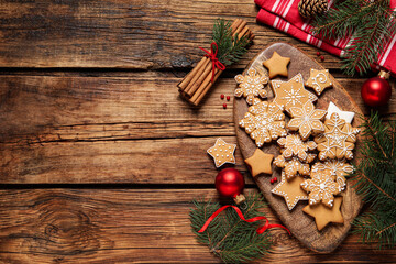 Flat lay composition with tasty Christmas cookies on wooden table. Space for text