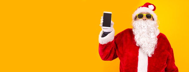 santa claus showing mobile phone with space for copy