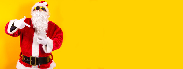 santa claus showing mobile phone with space for copy