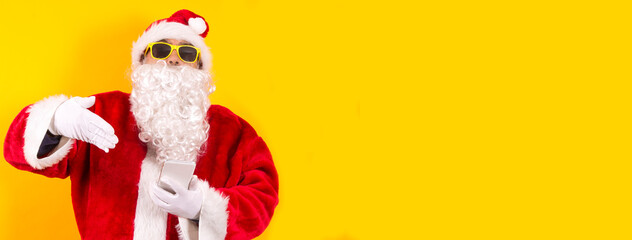 santa claus showing mobile phone with space for copy