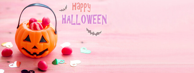 halloween composition with pumpkin, candy and bats