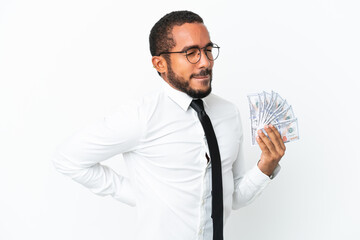 Young business latin man taking a lot of money isolated on white background suffering from backache for having made an effort
