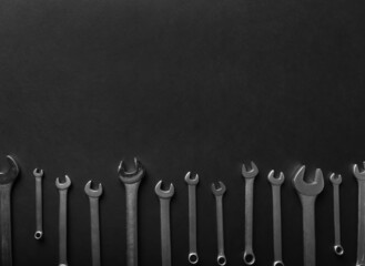 Adjustable wrench on black background