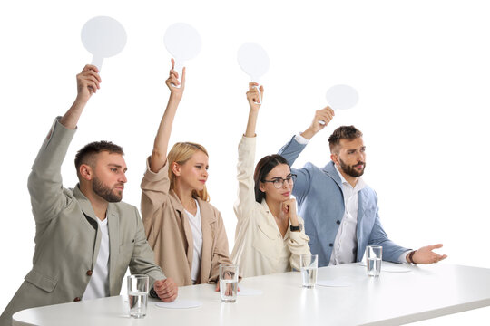 Panel of disappointed judges holding blank score signs at table on white background. Space for text