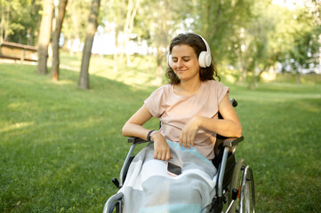 Disabled woman listens to music with headphones