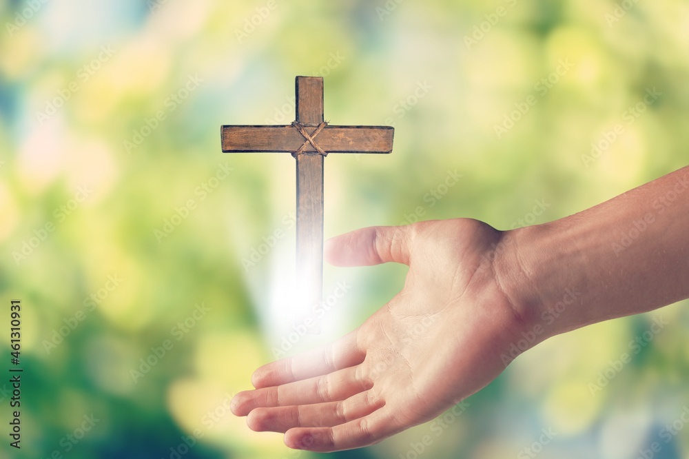 Poster wooden cross in the hand open palm of christian man worship pray to god