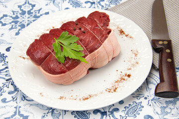 rôti de boeuf cru dans une assiette