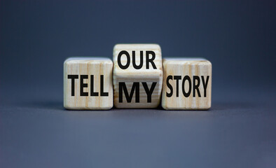 Tell my or our story. Turned wooden cubes and changed words tell my story to tell our story. Beautiful grey background, copy space. Business, storytelling and my or our story concept.