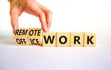 Remote or office work symbol. Businessman turns cubes and changes words 'office work' to 'remote work'. Beautiful white background. Business, remote or office working concept, copy space.