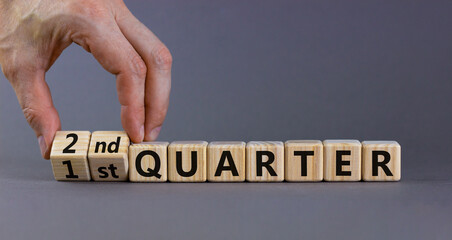 From 1st to 2nd quater symbol. Businessman turns cubes and changes words '1st quater' to '2nd...