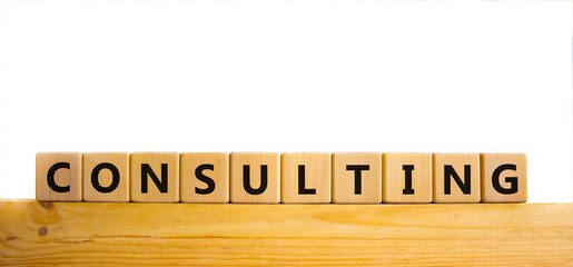 Consulting symbol. The word Consulting on wooden cubes. Beautiful wooden table, white background. Business and consulting concept. Copy space.