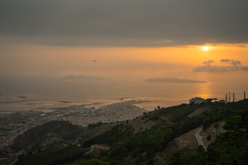 Trapani city and salt flats seaview at the sunset on a cloudy day, Sicily, Italy