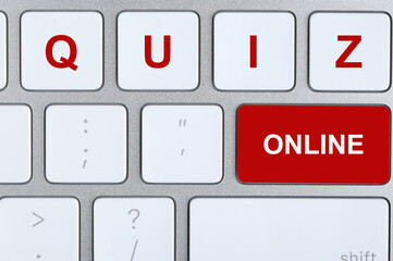Modern computer keyboard with text ONLINE QUIZ on buttons, top view