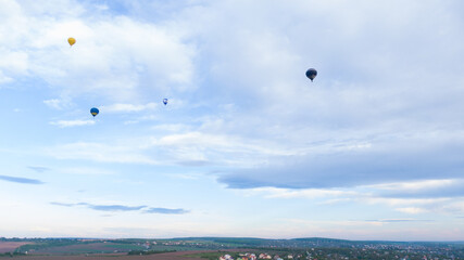 How to travel during quarantine. Hot air balloon. Colorful hot-air balloons flying over the village