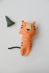 Handmade funny small tiger toy, symbol of new 2022 on white background