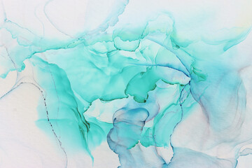 Fototapeta premium art photography of abstract fluid alcohol ink painting, blue and turquoise colors with paper texture