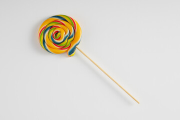 Bright coloured lollipop against a white background.
