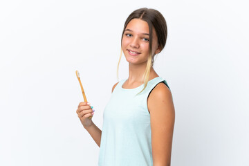 Little caucasian girl holding a toothbrush isolated on white background smiling a lot