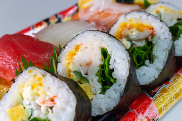 Closeup a pack of Makizushi and Nigiri Sushi sold by local supermarket in Japan. Makizushi is a type of sushi where sushi rice and a variety of ingredients such as Tamagoyaki, Kanpyo, Fish etc