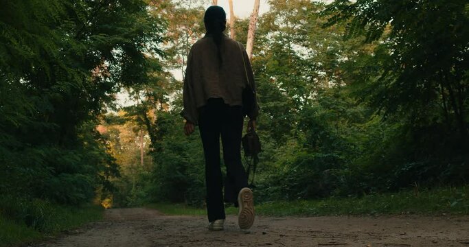 woman walks in forrest