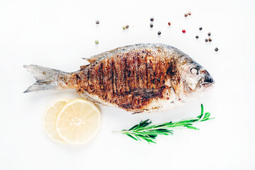 grilled dorado fish with lemon and rosemary on a white background, isolate