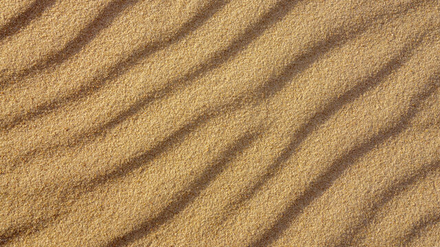 Brown wavy sand texture close up, beautiful natural natural background