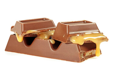 Tasty chocolate bar with caramel isolated on a white background. Broken candy bar.