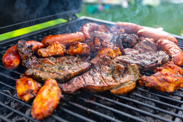 Grilled pork meat and sausages on the barbecue