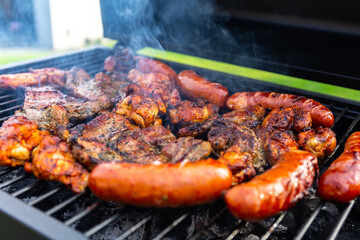 Grilled pork meat and sausages on the barbecue
